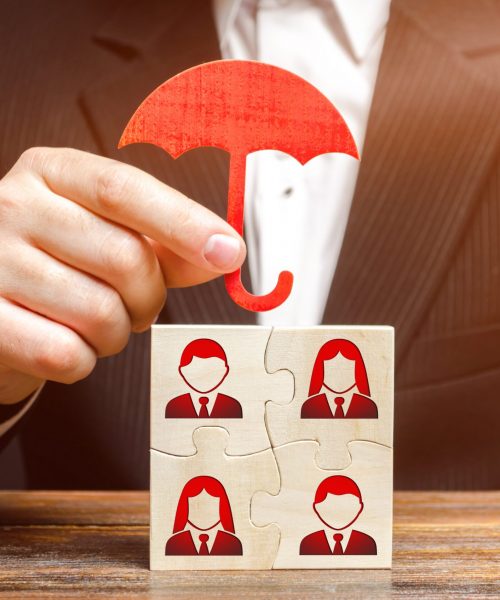 The businessman insures and protects the business team of employees. Team insurance, protection. Provision of an extensive range of solutions tailored to protect assets. Government business support. The businessman insures and protects the business team of employees. Team insurance, protection. Provision of an extensive range of solutions tailored to protect assets. Government business support.